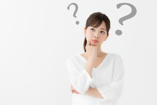 「悩んでいる女性が疑問を浮かべて考えている様子のイメージ。スキンケア選び・美容商品の比較・化粧品選択の迷いを表現」